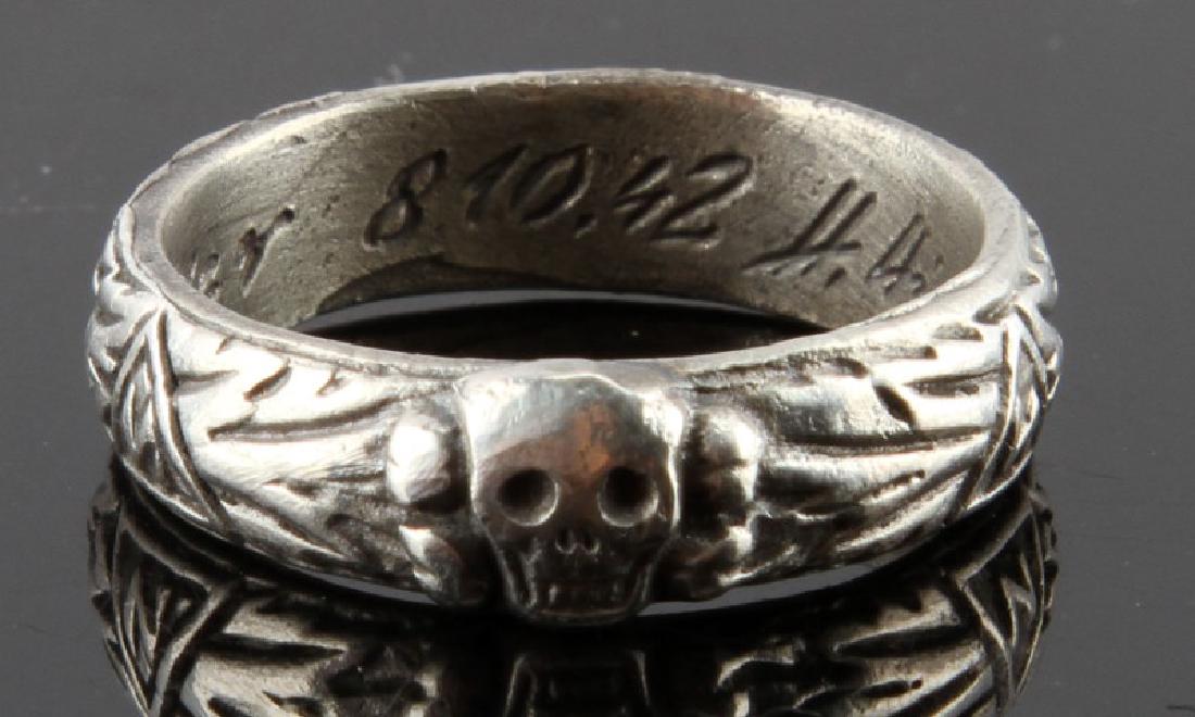 GERMAN WWII SS HONOR RING W HIMMLER SIGNATURE: Size 11 silver ring. Has signature of Himmler, date of award and name of recipient engraved inside of ring. Light wear/some discoloration present. Maker's mark to bottom of band. Very good condition. 