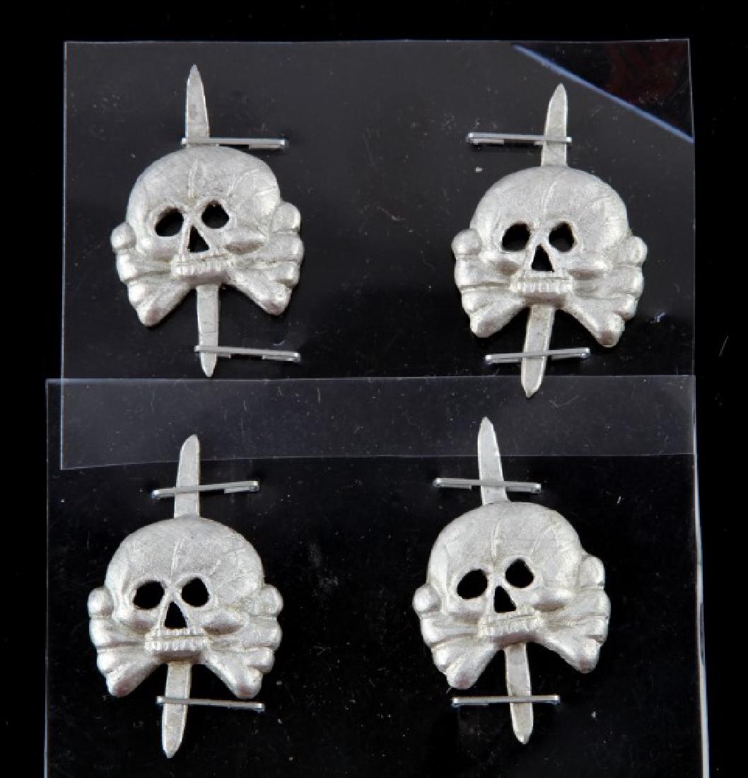LOT OF 4 GERMAN WWII PANZER JAWLESS SKULL BADGES: Group of four (4) German WWII skull badges. Each measures 1.5" (unbent, end to end). Very good condition. Unauthenticated. Sold "as is". This lot has a reserve.