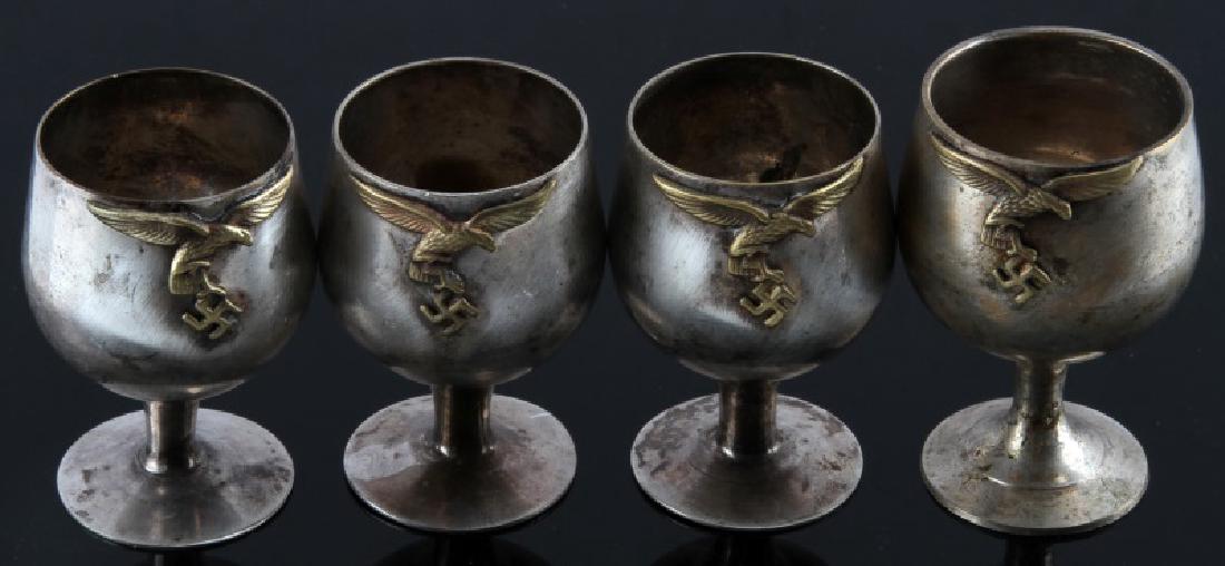 SET OF 4 WWII GERMAN LUFTWAFFE 3RD REICH SCHNAPPS CUPS: Set of four (4) German Third Reich period schnapps (vodka) cups from a Luftwaffe officer's canteen. Swastika eagle designs. Cups measure approx. 2 1/4" each (1 is a bit larger). Makers marks on bottom
