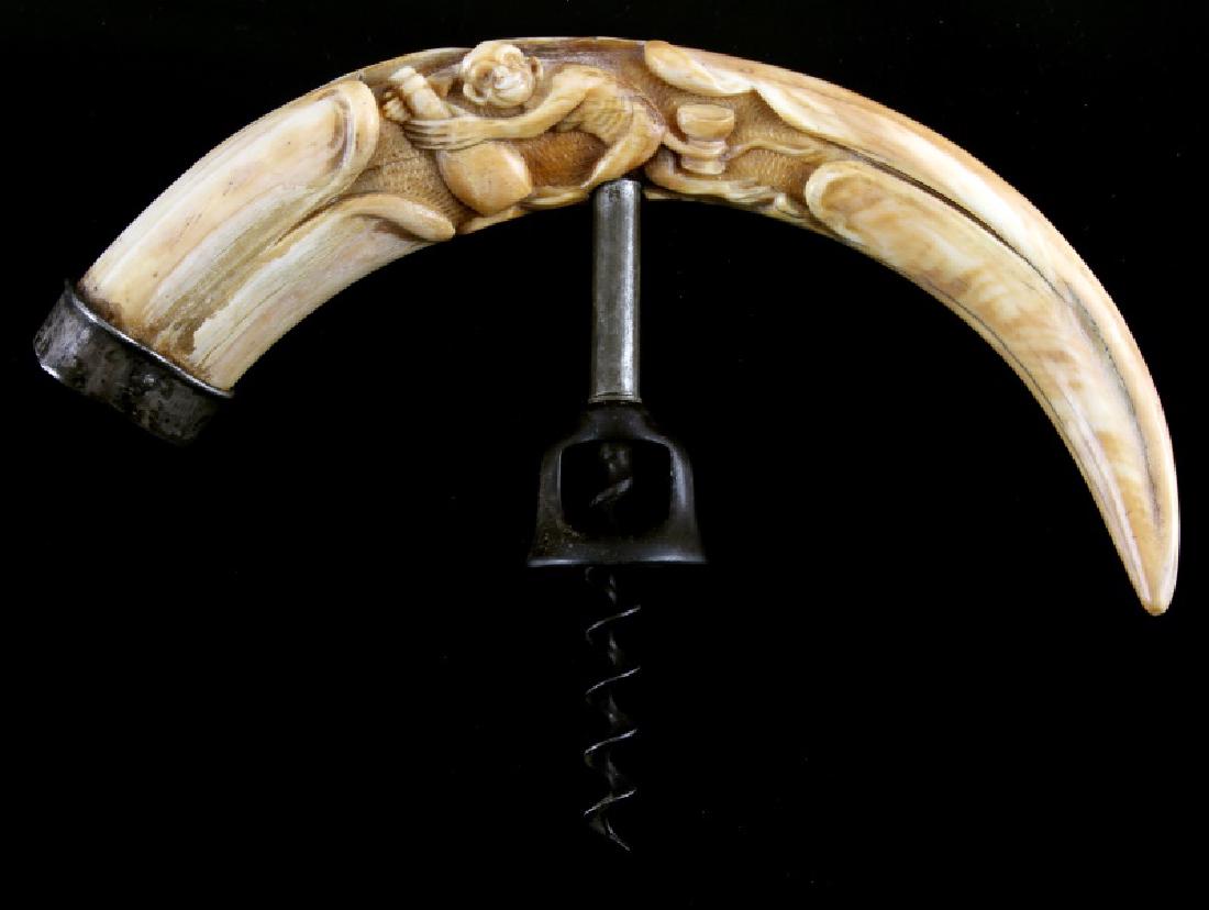 ANTIQUE SILVER CAPPED CARVED BOAR TUSK CORKSCREW: Boar tusk corkscrew with an intricate carving of a mischievous monkey, running with a bottle in his hands and a goblet wrapped in his tail. Tusk measures approximately 9 1/8" on a curve. Measures appr