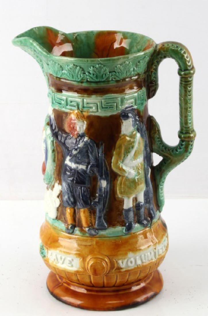 ANTIQUE VICTORIAN ERA BRITISH BOER WAR PITCHER: 10 1/4" Victorian era British Boer war majolica pitcher. British date mark to underside. Depicts Royal guards and soldiers, along with image of the Queen and the writing "Our Army & Navy & Brave Volun