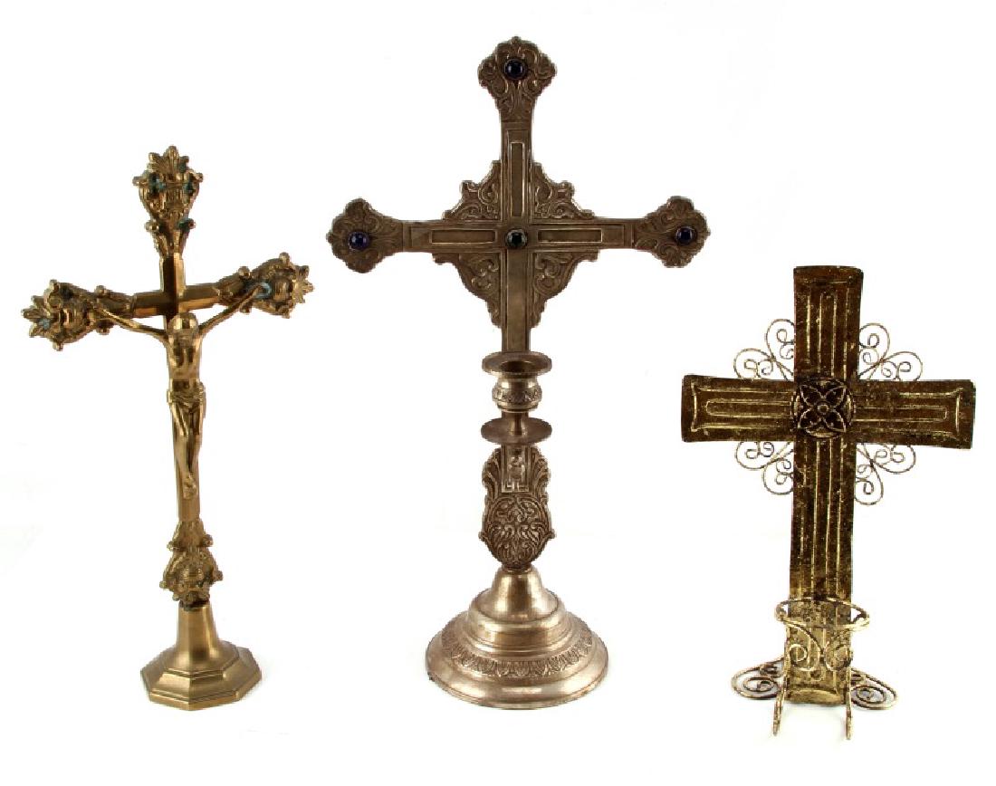 THREE ANTIQUE METAL CANDLESTICK CRUCIFIXES: Three Roman Catholic crucifixes, two candle holders or candlesticks. Range in height from 12" to 18". Stand out piece in lot is silver-toned, with cobalt pieces on end points. Weighs 3.8 lbs, and enti