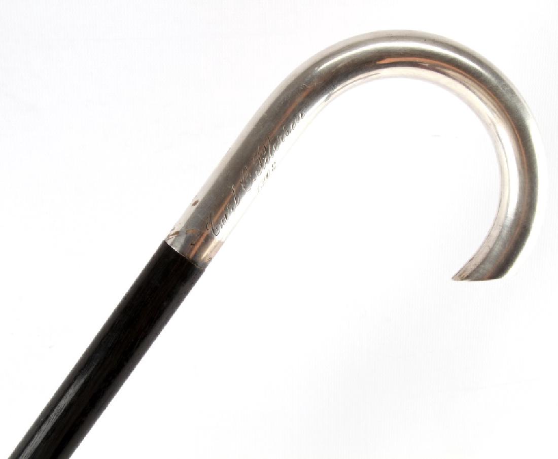 EBONY WOOD 830 SILVER NAMED HANDLE 1908: One walking cane. Item has an ebony wood shaft, an 830 silver marked handle, and a name on the handle Carl C Peterson, with a date beneath it that says 1908. Ferrule tip is in good condition. Very nic