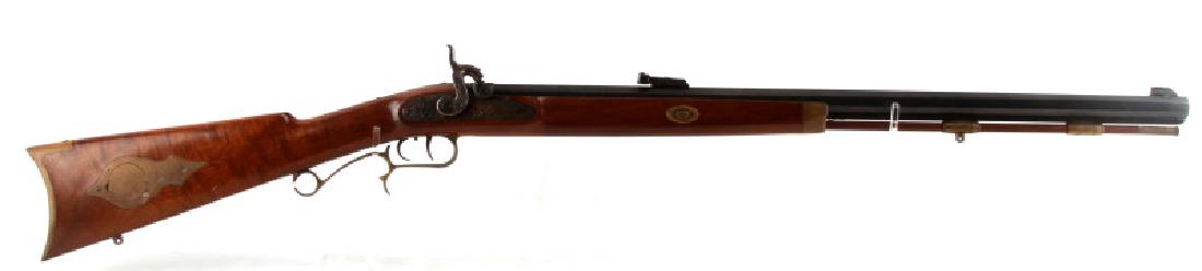 THOMPSON CENTER ARMS 50CAL MUZZLE LOADER RIFLE: Thompson Center Arms. 50 caliber muzzle loader rifle. In excellent condition. Wood has no cracks and only very minor scratching. Hammer and plate feature intricate design work. Caliber: .50 Serial #: 
