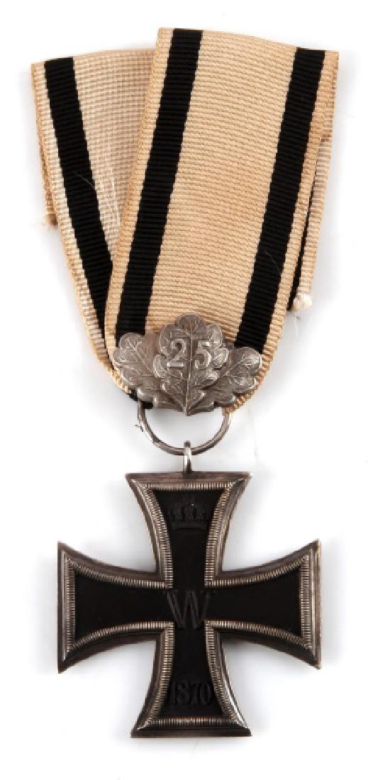 GERMAN 1970 IRON CROSS W 25 YR OAK LEAVES & RIBBON: 1870 Iron cross with 25 year oak leaves for non-combatant. On white silk ribbon with black stripes. Real silver frames with magnetic center. Minor tarnishing and ribbon has light fraying. This lot has