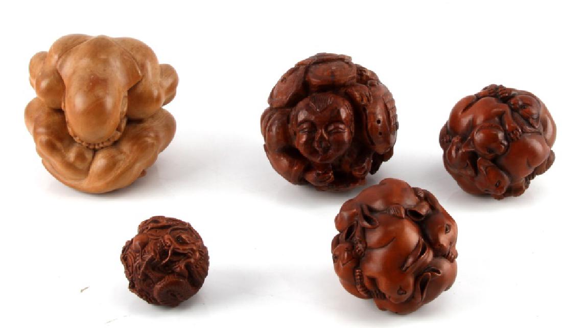 LOT OF 5 CARVED JAPANESE NETSUKE WOOD BALLS: Lot of 5 balls of figural animals and more, ranging in diameter from 6" to 10". All in very good condition, one with a crack.