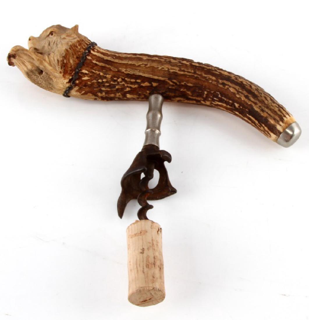 CARVED ANTIQUE BOVINE ANTLER CORKSCREW: Carved calf face into the end of the antler, which measures approximately 8" long (measured on a curve), and measures 5" from end of screw to top of handle. Weighs 279 grams total. In very good condit