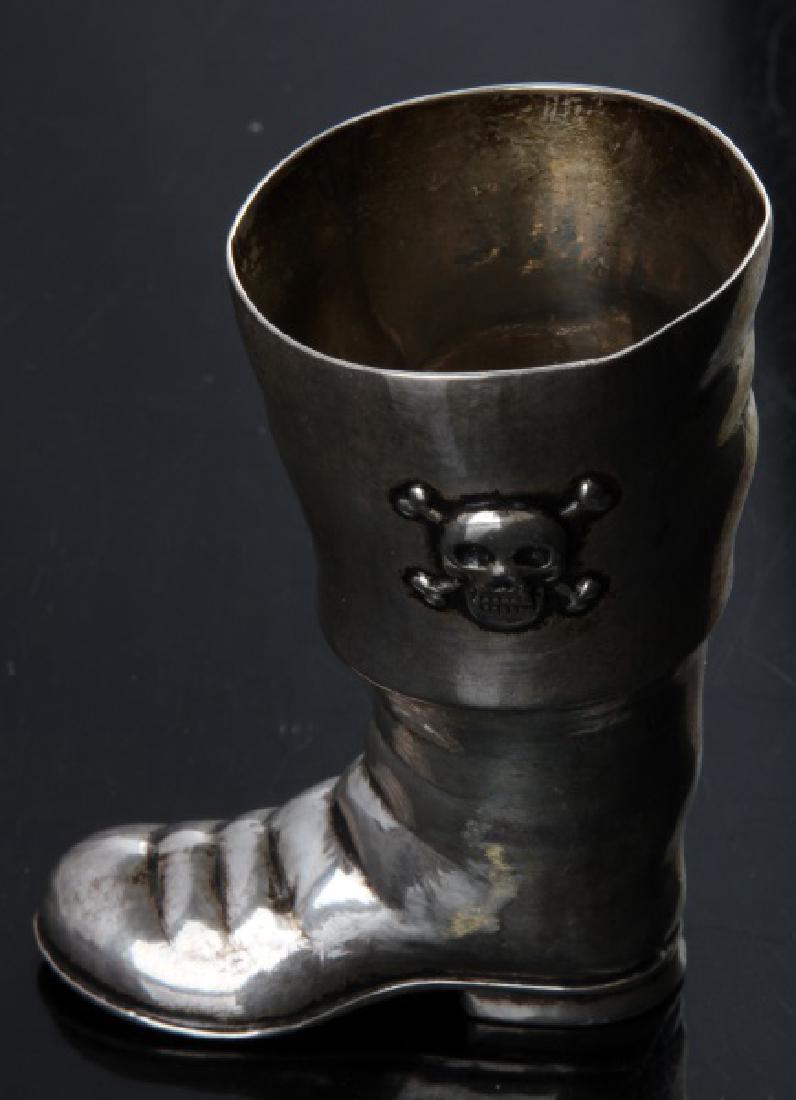 SMALL STERLING SILVER PIRATE BOOT 45.5G: Small sterling silver boot. Weight is 45.5 grams. Features skull and cross bones on left side. Minor tarnishing.