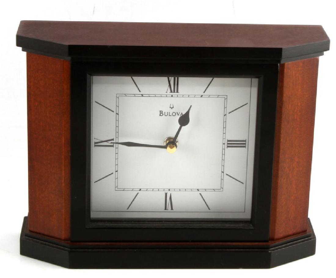 BULOVA B1881 HOLYOKE MANTEL CLOCK CHERRY FINISH: In excellent condition, which measures approximately 9 1/2" by 7 1/2". Comes with original box with original papers. Walnut wood case. This lot has a reserve.