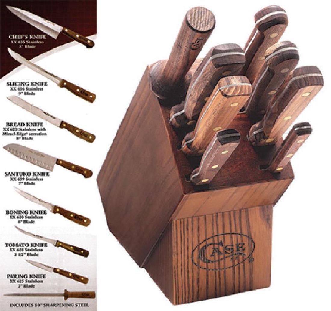 CASE XX KITCHEN CUTLERY NINE PIECE KNIFE BLOCK SET: Includes: 8" chef knife, 9" slicing knife, 8" bread knife, 7" Santuko knife, 6" boning knife, 5 1/2" tomato knife, 3" pairing knife, 10" sharpening steel. New in box. Textured plastic grips. Image is