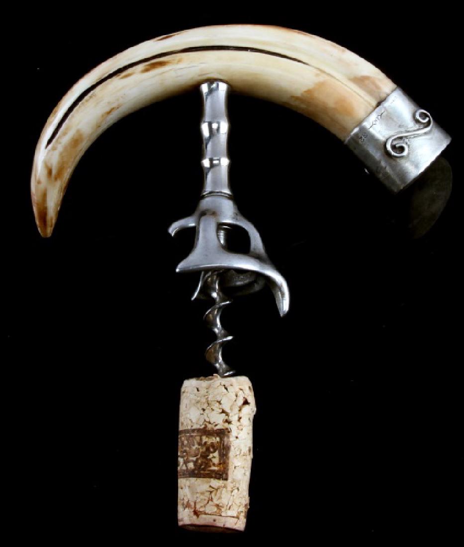 ANTIQUE BOAR TUSK & STERLING CORKSCREW: Finel polished tusk and sterling with makers mark cap, measures along the curve 8 inches.