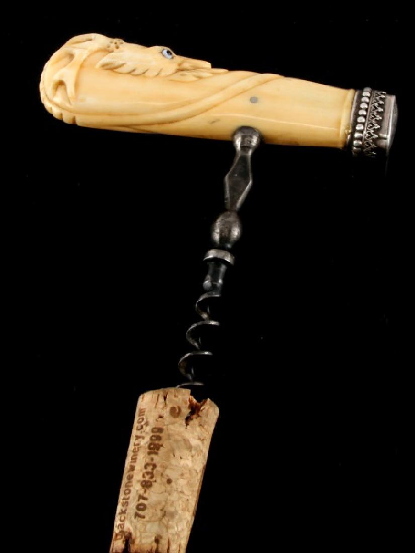 ANTIQUE SCRIMSHAW STAG HEAD CARVED CORKSCREW: Walrus scrimshaw with glass eyes and sterling cap. Measures 5 inches. Provenance Ex: pre 1972 Memphis estate. we cannot ship international and please know your state regulations prior to bidding.