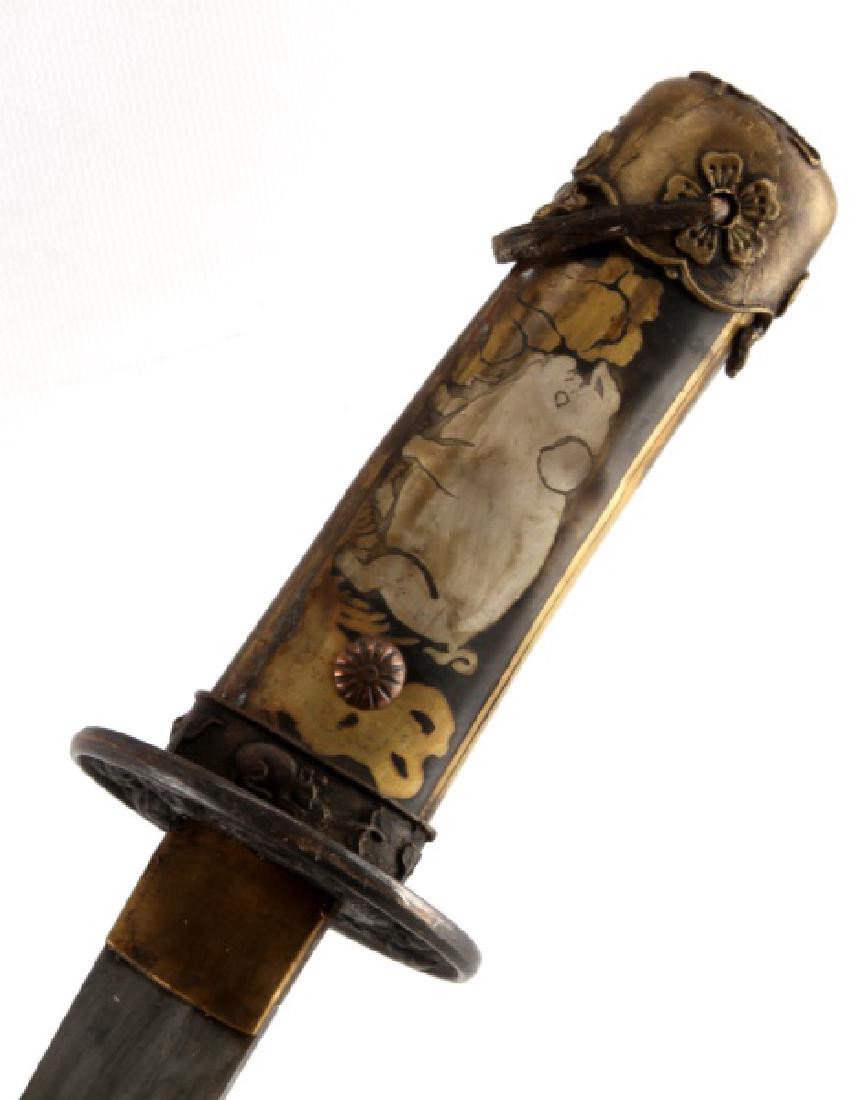 JAPANESE FIGURAL PASTORAL SCENE TANTO WITH SHEATH: Tanto measures approximately 14 1/4" in total length, with a blade measuring 9". Sheath depicts figural pig, monkey, horse, ox, and bird on a pastoral landscape. Wooden or bamboo sheath with brass fit