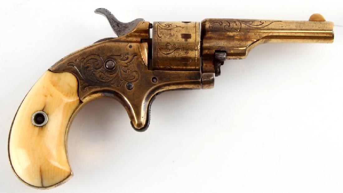 ENGRAVED GOLD & TUSK COLT OPEN TOP POCKET .22 SA: One Colt Open Top 22 caliber single action revolver. Handle is tusk, original to the gun, over 100 years old, and weighs no more than 35 grams. 7 shot 22 caliber single action. Gold colored finish has
