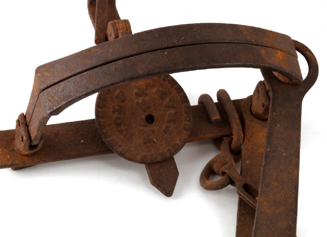 TWO ANTIQUE CAST IRON BEAVER TRAPS CIRCA 1840S: Lot of two antique beaver traps. One is blacksmith made, and one is Newhouse. The Newhouse trap has a hook-like anchor attached to it, and the blacksmith one has a chain with a loop at the end. Blacks