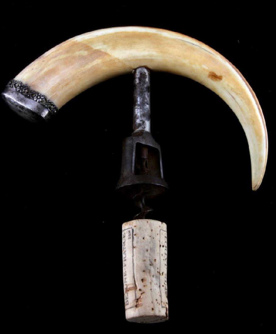 ANTIQUE BOAR TUSK & STERLING ANTIQUE CORKSCREW: Decorated and stamped sterling cap, handle measures along the curve 9 inches.