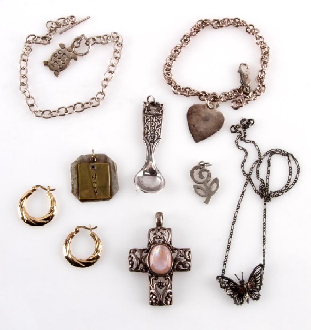 ASSORTED STERLING SILVER 925 VINTAGE JEWELRY: Lot of vintage sterling silver jewelry. Includes two bracelets, a pair of hoop earring, a silver cross with a pink stone, and more. Weighs 46 grams total. Conditions range from good to very good.