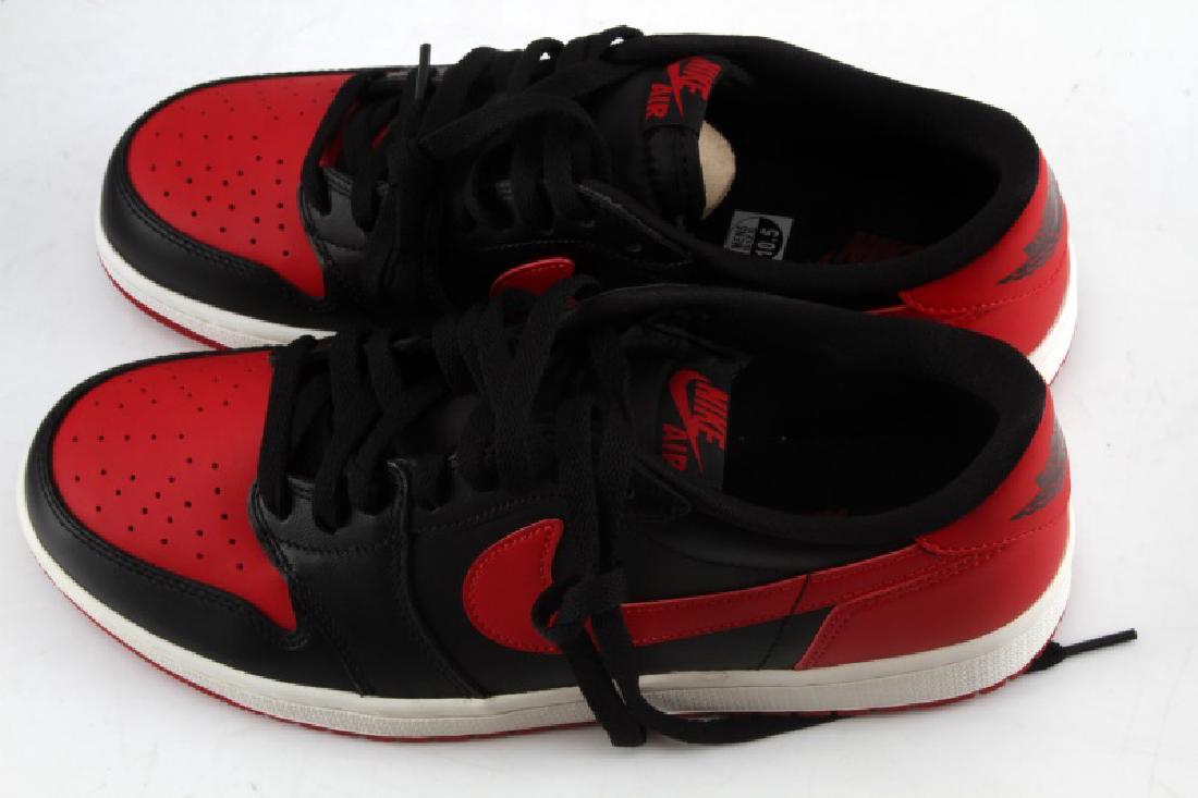 NIKE AIR JORDAN 1 RETRO LOW OG SNEAKERS BRAND NEW: Authentic Nike Air Jordan sneakers brand new in box. Size 10.5 (U.S.). Color is black with varsity red accents. Both sides have classic Nike "swoosh" with Air Jordan logo on back.