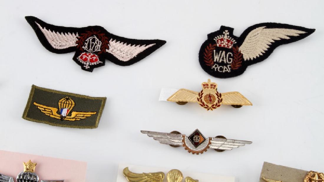 ASSORTED LOT OF 24 MILITARY WING BADGES: Lot of twenty-four (24) foreign paramilitary badges includes RAF BWRS "Bundles for Britain" homefront pin, RCAF cap badge, Peru Para, Iran basic Para, Indonesia Marine basic Para, Guatemala basic Para