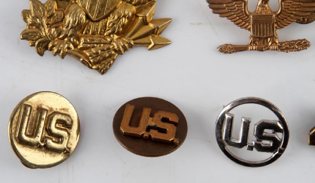LOT OF US ARMY MEDALS INSIGNIA AND PINS: Lot of US Army medal, insignias, and pins. Includes 1 gold plated eagle metal insignia, 2 Colonel rank metal insignia, 4 US metal insignia's, 483 metal insignia, 2 40/8 metal insignia.