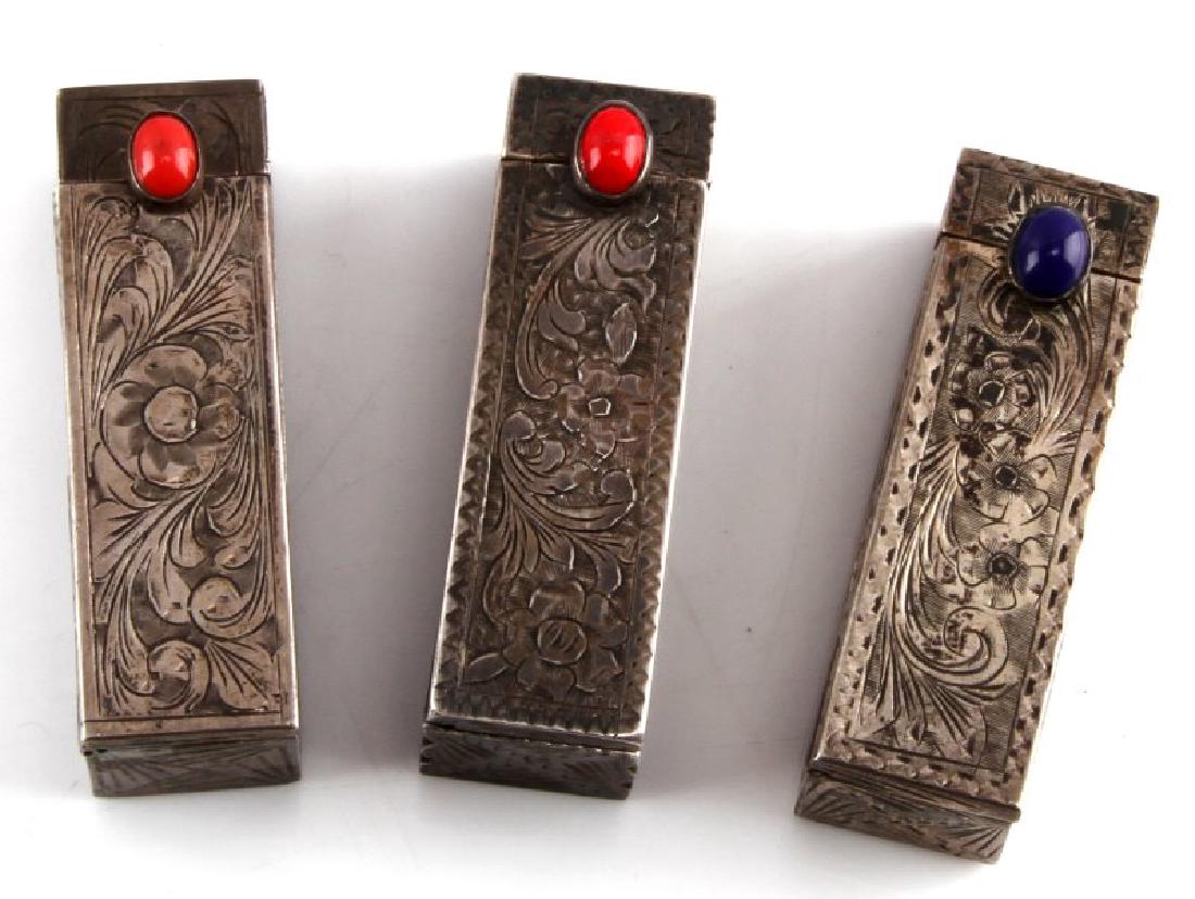 EVA BRAUN SILVER MONOGRAMMED LIPSTICK HOLDERS 3: Three engraved silver lipstick holders that belonged to Eva Braun, Adolf Hitler's mistress then wife. Scroll design and her initials to the inside where top flips open to a mirror. Two holders still h