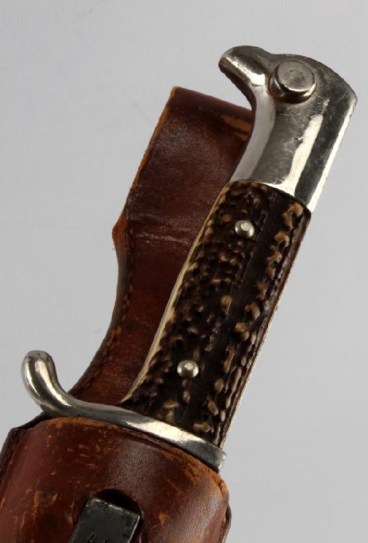 WWII THIRD REICH LONG STAG HANDLE PARADE BAYONET: Base of blade measures, "ANTON WINGEN JR SOLINGEN". Measures 14 3/4", with a blade that measures 10". Sheath with frog, marked, "17". In very good condition with some wear to blade and frog, and dark 