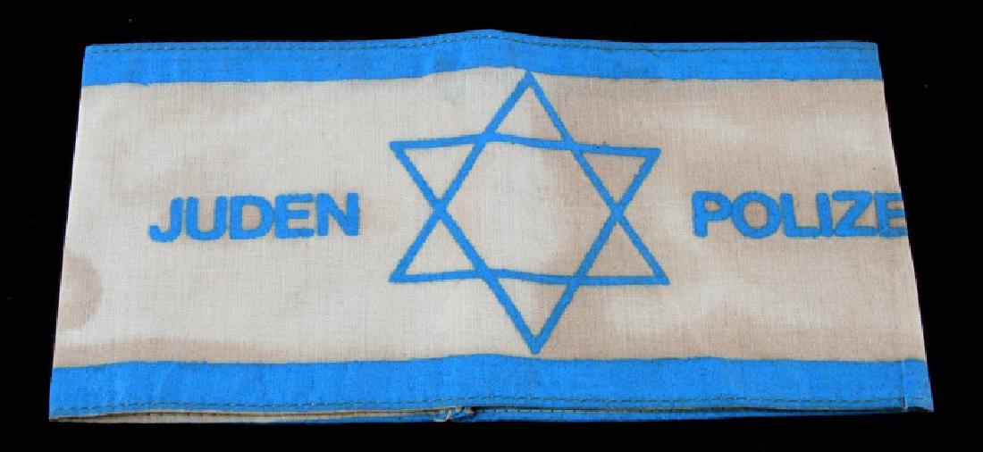 GERMAN WWII JUDEN POLIZEI ARM BAND BLUE WHITE: German WWII Juden Polizei (Jewish Ghetto Police) armband. White cotton construction with blue border and letters. Features strong staining from usage.
