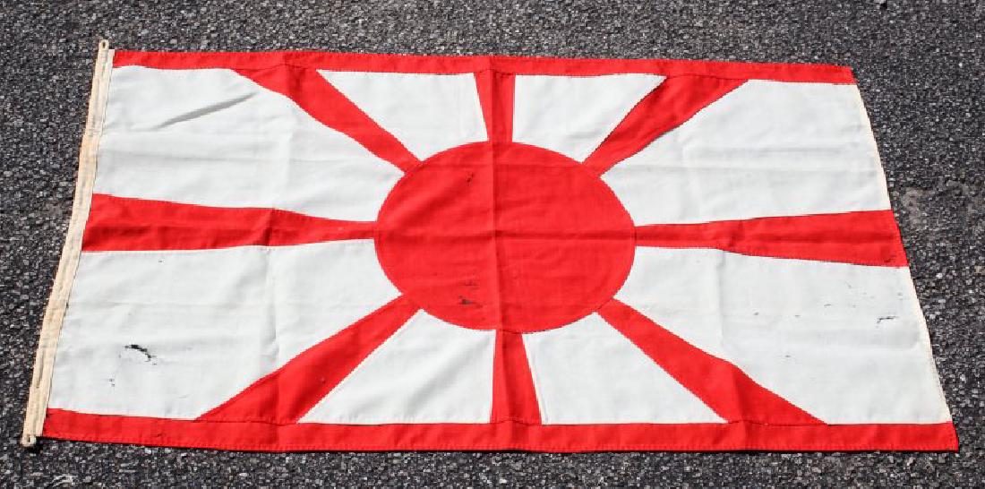 WWII IMPERIAL JAPANESE NAVY NAVAL RISING SUN FLAG: Measures 54" by 35". In good condition with some holes throughout. Double-sided with stitching apparent throughout.