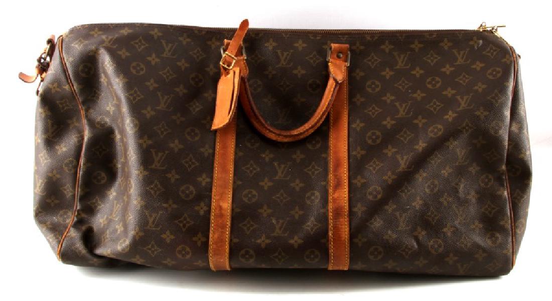 LUIS VUITTON MONOGRAMMED DUFFEL BAG: Luis Vuitton monogrammed duffel bag. In very good condition. Minor wear on leather straps. Pin holes in base. Normal scuffing from usage. Made in France. Unauthenticated, sold as is.