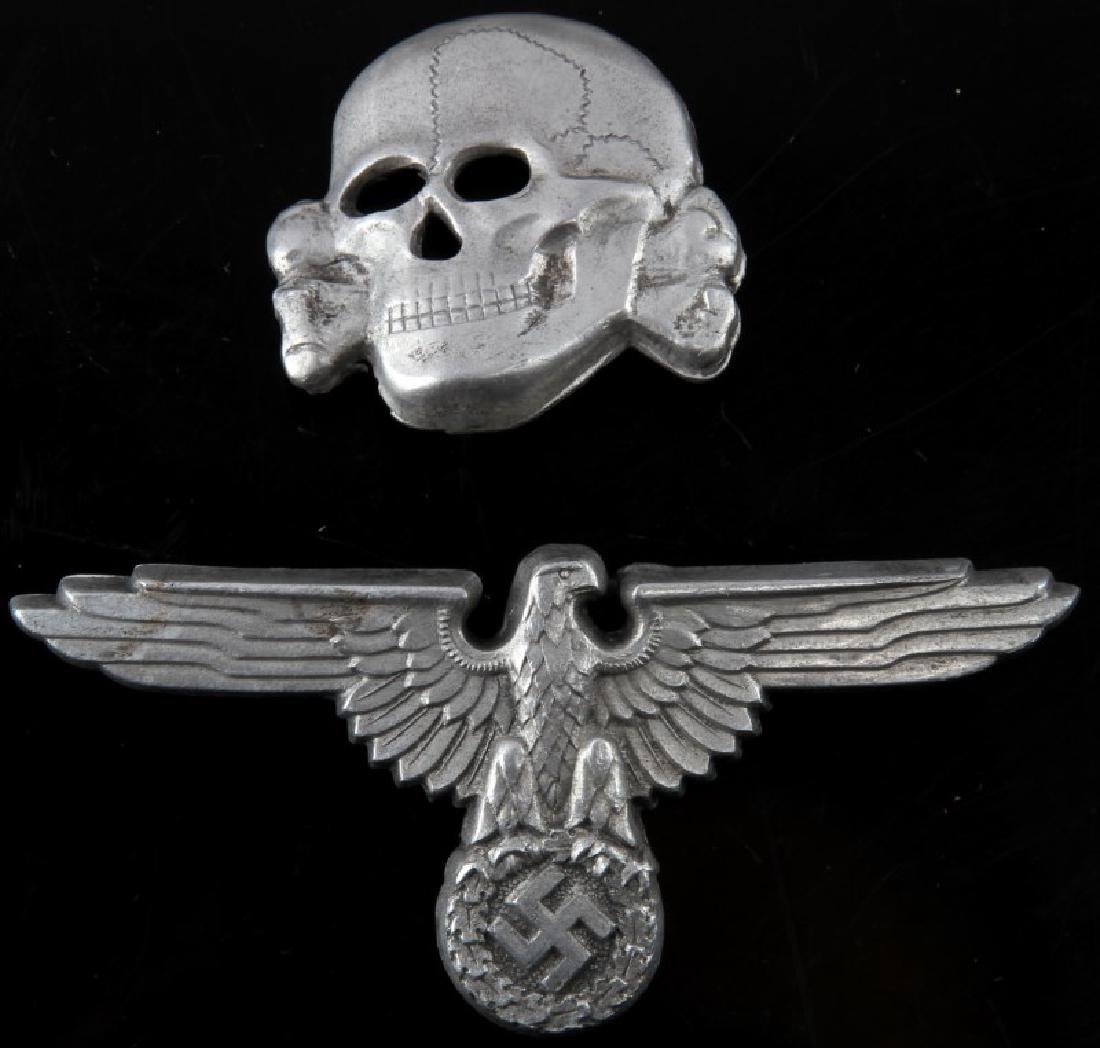 WWII GERMAN 3RD REICH SS VISOR CAP EAGLE AND SKULL: Aluminum eagle and totenkopf. Eagle is marked RZM SS/499 and M1/72. The skull is marked RZM 499/41. Unauthenticated sold as is. This lot has a reserve.