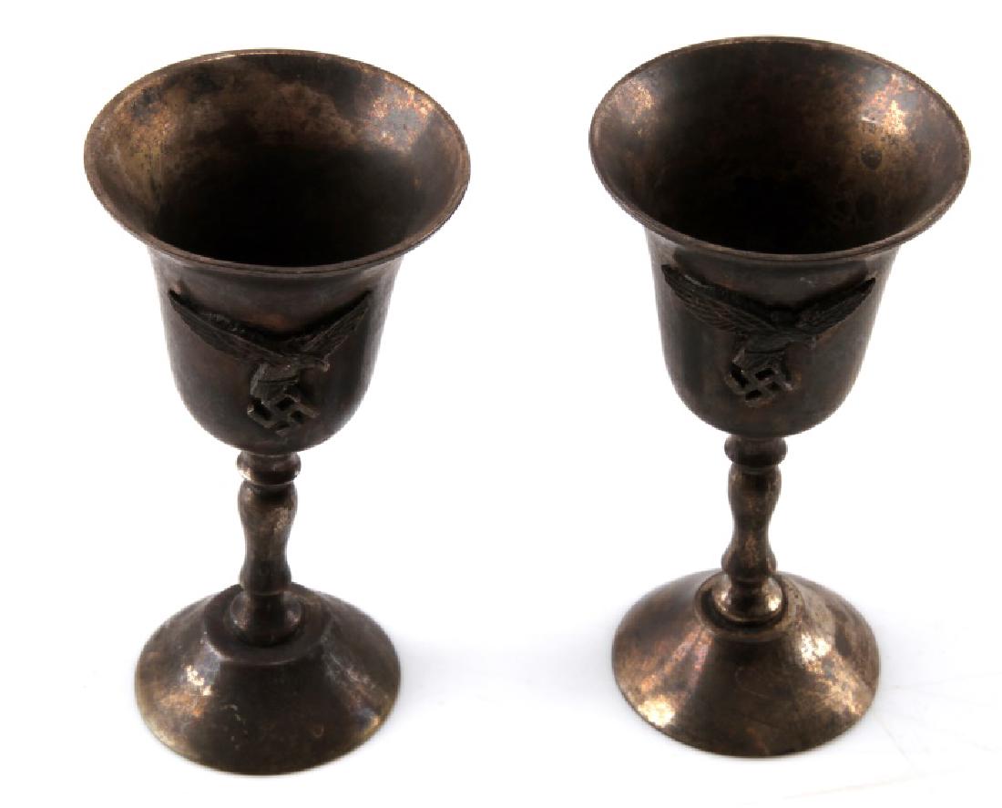 GERMAN WWII 2 LUFTWAFFE SMALL SILVER CHALICES: German WWII 2 Luftwaffe small silver chalices. Features Luftwaffe eagle insignia on exterior. Measure 3 3/4" tall and 2 inches in diameter. Strong tarnishing. Good conditon.