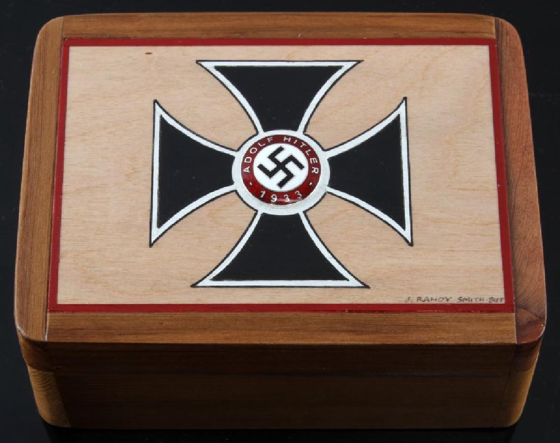 HAND PAINTED IRON CROSS CEDAR WOOD BOX W PARTY PIN: Box Measures 4 1/2" 6 1/4" and 1 1/2" deep. Has a painted iron cross with a round Hitler disc dated 1933 with central angled Swastika. All modern not from WWII era. Signed by artist J. Randy Smith.