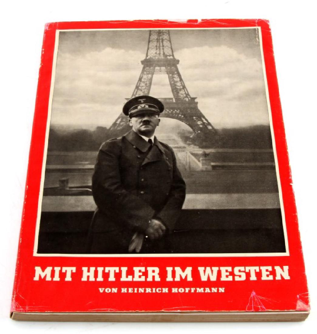 GERMAN WWII PHOTO ALBUM MIT HITLER IM WESTEN: German WWII photo album "With Hitler in Poland" by Heinrich Hoffmann. Printed in 1940. Cover sleeve has some wear. Some staining to pages. Book in very good condition. This lot has a reserve.