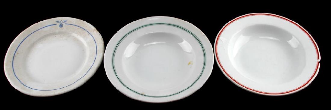 WWII GERMAN THIRD REICH DINNER PLATE LOT OF 3: Includes a blue trim Porsgruhn PP Norge with a diameter of 9 3/8" (front features eagle insignia), green trim KPM 1941 dated bowl with eagle insignia on back, and a red trim Savaria bowl. Savaria bowl