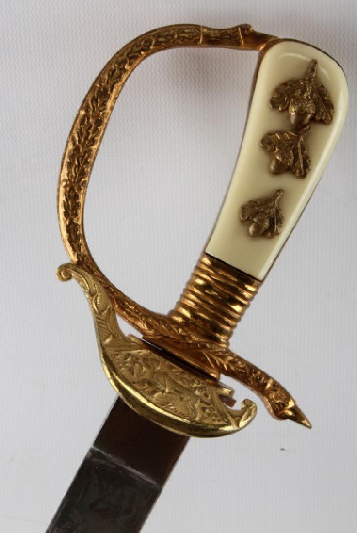 WWII GERMAN SENIOR FORESTRY CUTLASS DAGGER: Gilded acorn and wreath motif with cream bakelite grips, dog to front piece, and etched hunting scene to each side. Blade measures 11 5/8 inches and is unmarked. Sharp tip and leather washer in place.