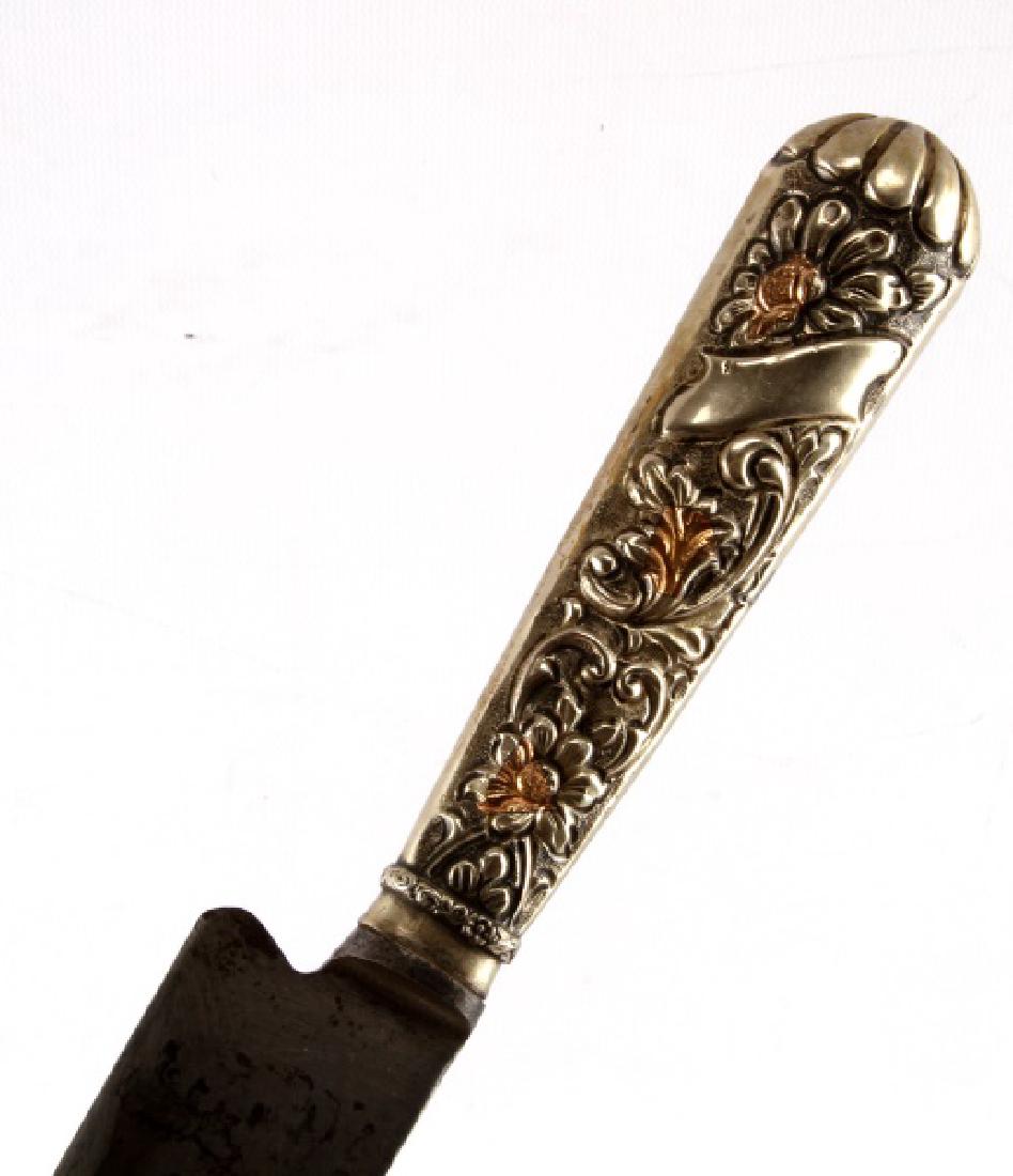 ARGENTINE GAUCHO FIGHTING AND CAMP KNIFE: Argentine Gaucho knife of the "cuchillo" style, essentially a large, heavy butchers knife usable as a multipurpose tool and weapon. Full tang construction with a 12 inch blade. Metal hilt and scabbard