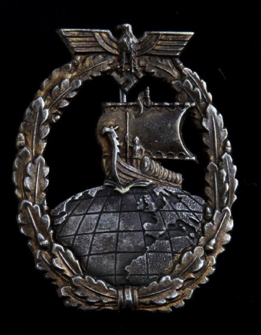 GERMAN WWII AUXILIARY BADGE MAKER STAMPED: German WWII Auxiliary Badge. Features maker stamp Friedrich Keller Obertstein. Minimal tarnishing. Thin vertical pin back.