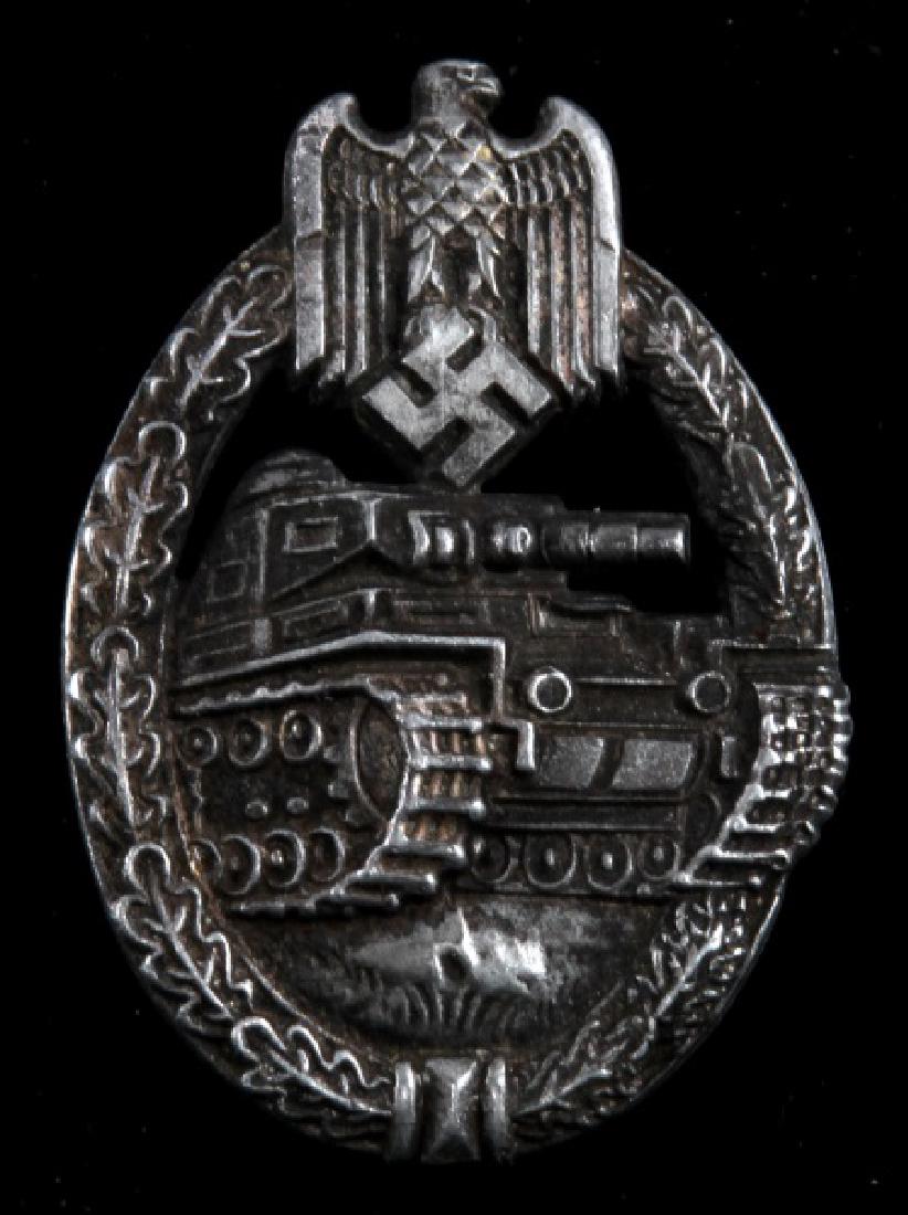 GERMAN WWII PANZER ASSAULT BADGE RRS STAMPED: German WWII late war Panzer Assault badge. Silver class. Marked RRS on reverse. Thin vertical pin back. Tarnishing as expected with age.