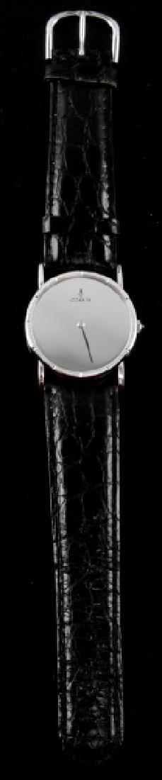 VINTAGE MENS CORUM MIRROR WRIST WATCH BLK BAND: Round face watch measuring 30mm across with mirror face and Corum logo to top. No numbers on face. Stainless bezel and case with numbers 57255-01 and 139303 to back with logo again. Size 22 black leat