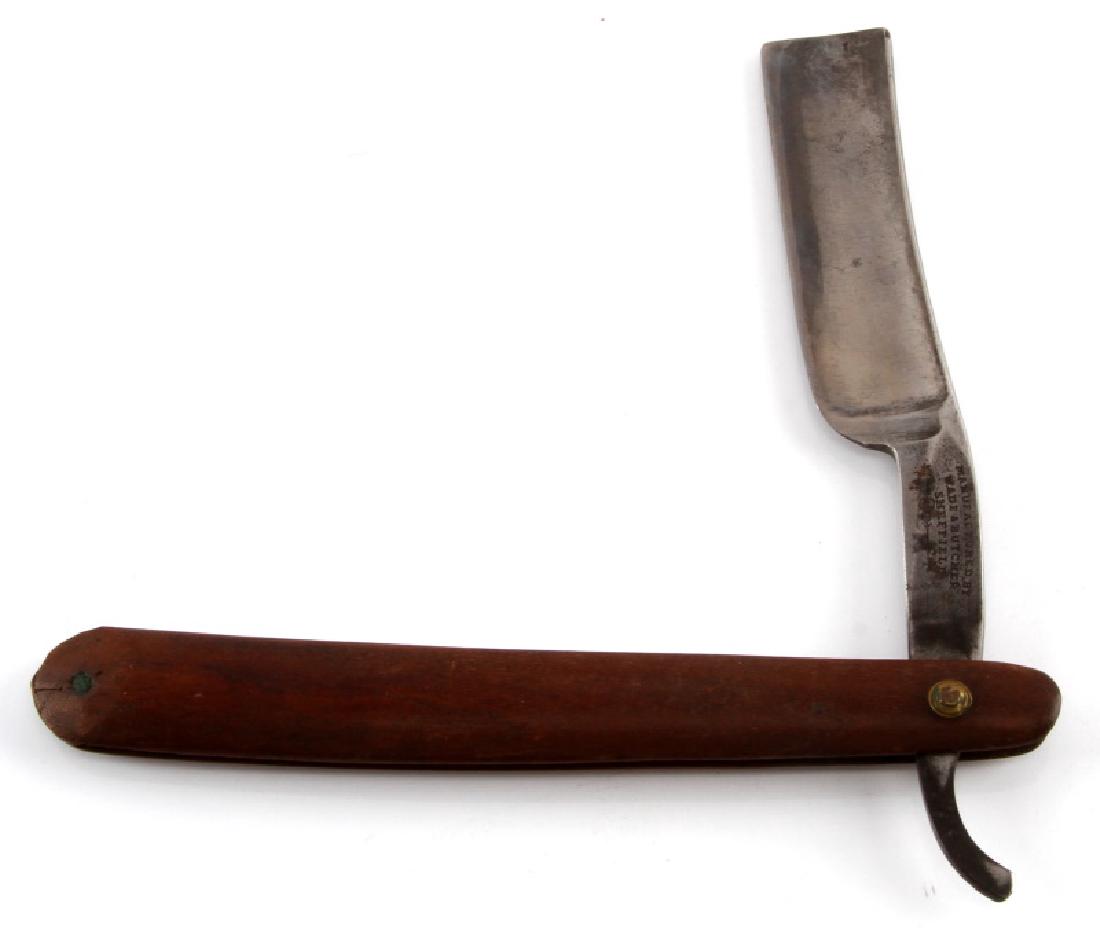 ANTIQUE WADE & BUTCHER SHEFFIELD STRAIGHT RAZOR: Antique Wade & Butcher Sheffield straight edged razor. Wooden handle with brass rivet. Measures 9 3/4" opened, 6 3/8" in closed position. Blade has some tarnish, some wear to handle. Overall in very g