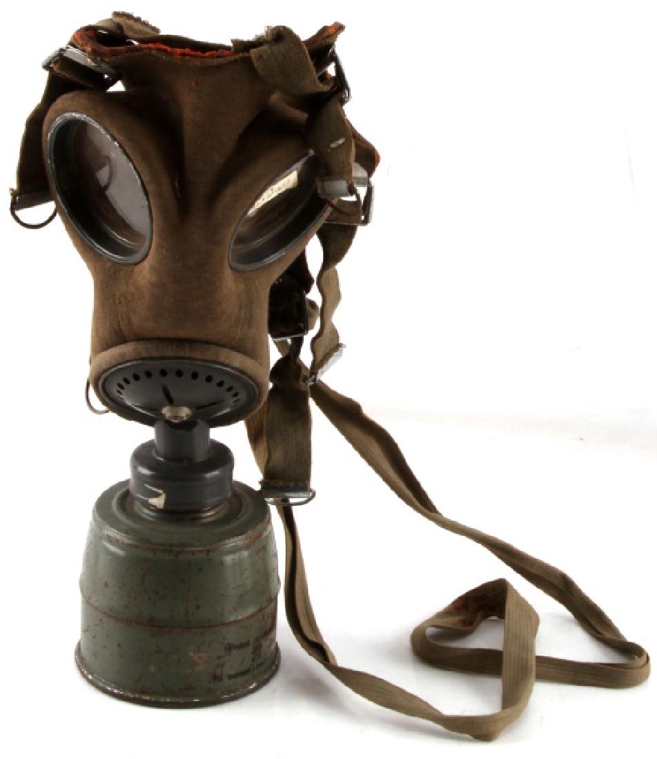 POST WWII ERA EASTERN EUROPEAN GAS MASK W FILTER: Post-WWII era Eastern European Gas mask with filter original fog glasses and the original filter canister, which had some patina or corrosion with markings and makers marks on the obverse of base. In