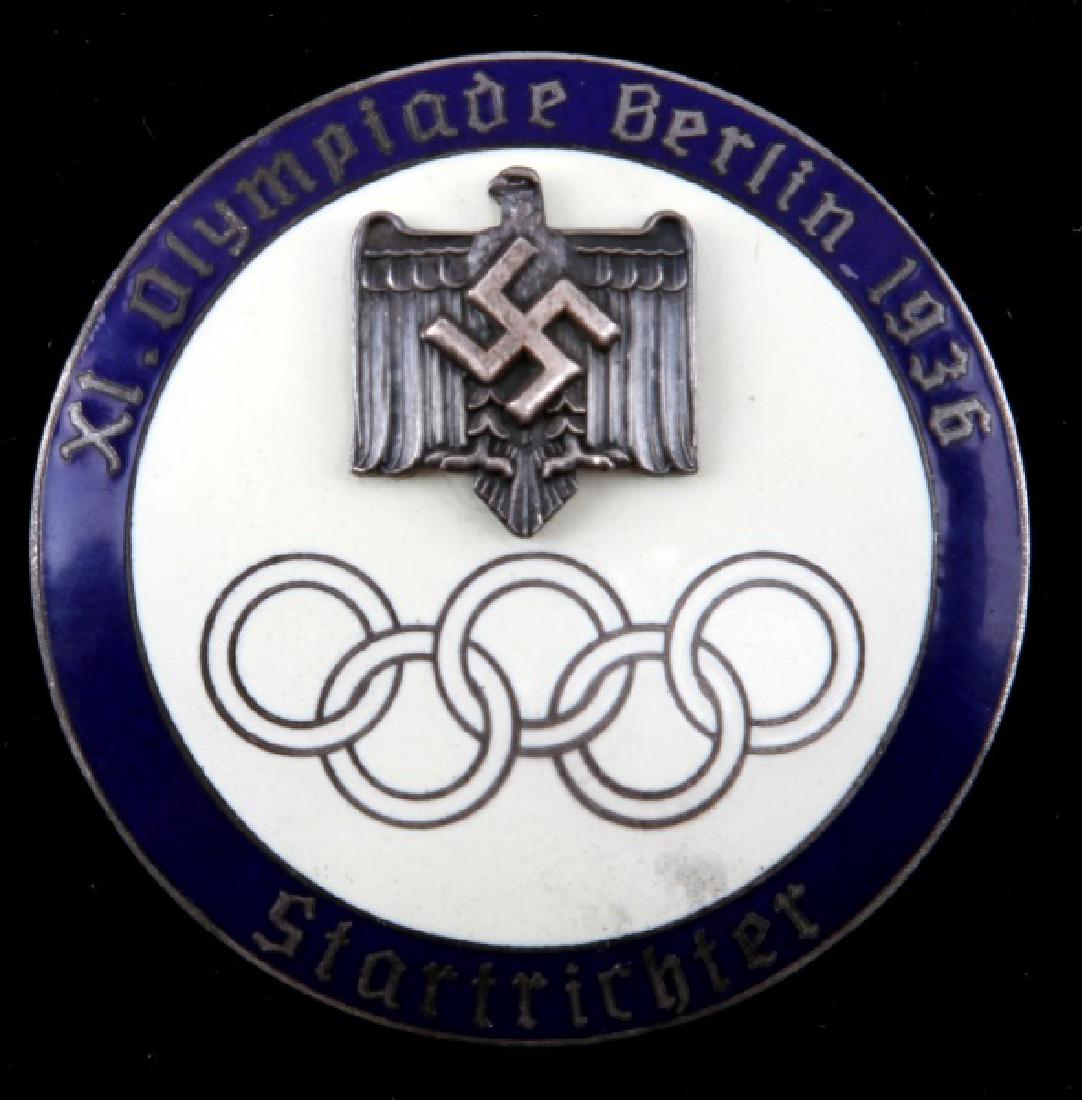 1936 GERMAN BERLIN OLYMPIC STARTRICHTER BADGE: In very good condition with a vertical straight pin back. The back is marked GES. GESCH and a diamond logo with PC in it. This lot has a reserve.