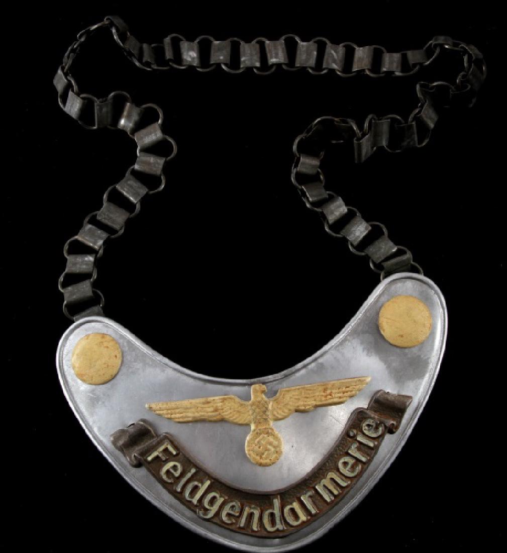 WWII GERMAN 3RD REICH ARMY FIELDZHANDARM GORGET: Gorget reads "Feldgendarmerie" with chain. "RZM" and other maker's markings. Measures 6 1/2" end to end. Some wear. Unauthenticated. Sold "as is". This lot has a reserve.