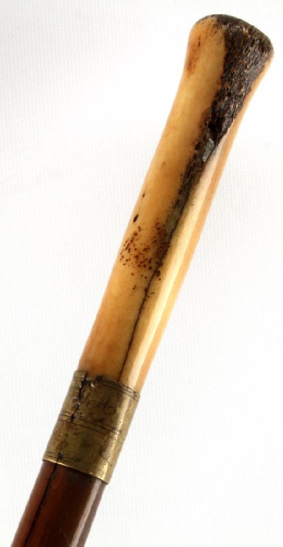 ANTIQUE WALKING SWORD CANE BONE GRIP BRASS COLLAR: Features 5 inch bone handle, brass collars and ferrule, brown wood, 30.5 inch blade. Initials "ITA" to top collar. Mottled patina, little pitting to blade. One crack in bone grip. Some splitting of wo