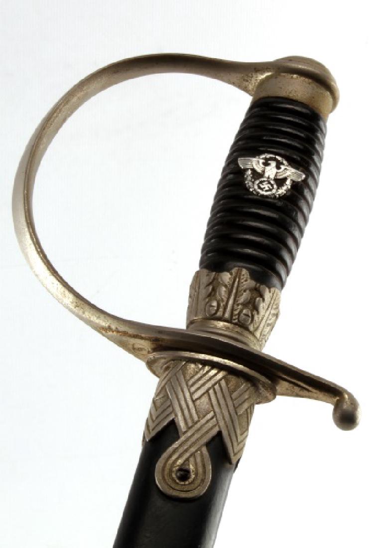 WWII GERMAN THIRD REICH SS NC OFFICER DEGEN SWORD: Dress degen sword of an SS non-commissioned officer. Comes with scabbard, but not portepee. Lot is in good condition, with some rust on the handle and blade. Ebony paint on the scabbard has worn in pl