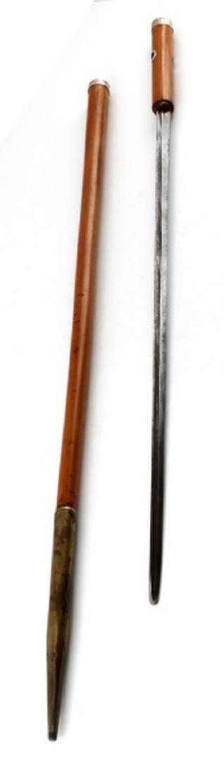 ANTIQUE WOODEN SWORD CANE WALKING STICK: Wooden sword cane. Overall length is 35 1/2 inches. Sword length is 28 1/2 inches, and the blade is 22 1/2 inches. Silver wrap handle with hole for lanyard. In very good condition with some scratches 
