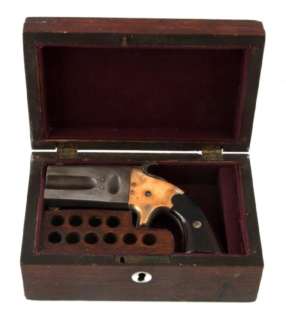 AMERICAN ARMS CO PATENT 1866 O/U .41 RF PISTOL: Double barrel pistol with walnut grips, brass frame, and maker marked to top rib. Fluted barrels measure 2 5/8 inches with half moon sight, patent date underneath, and serial no. 1085 to butt strap. B