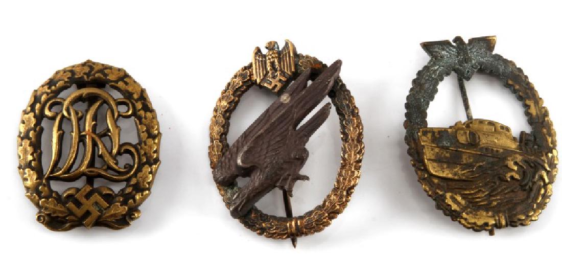 3 WWII GERMAN MILITARY BADGE LOT SPORTS LUFTWAFFE: Lot of three (3) includes: Kreigsmarine E-Boat, Nazi "SA" DRL sports badge, and Luftwaffe Paratrooper badge. Some age wear and verdigris. Luftwaffe badge has two-piece construction, plus pinback. Spor