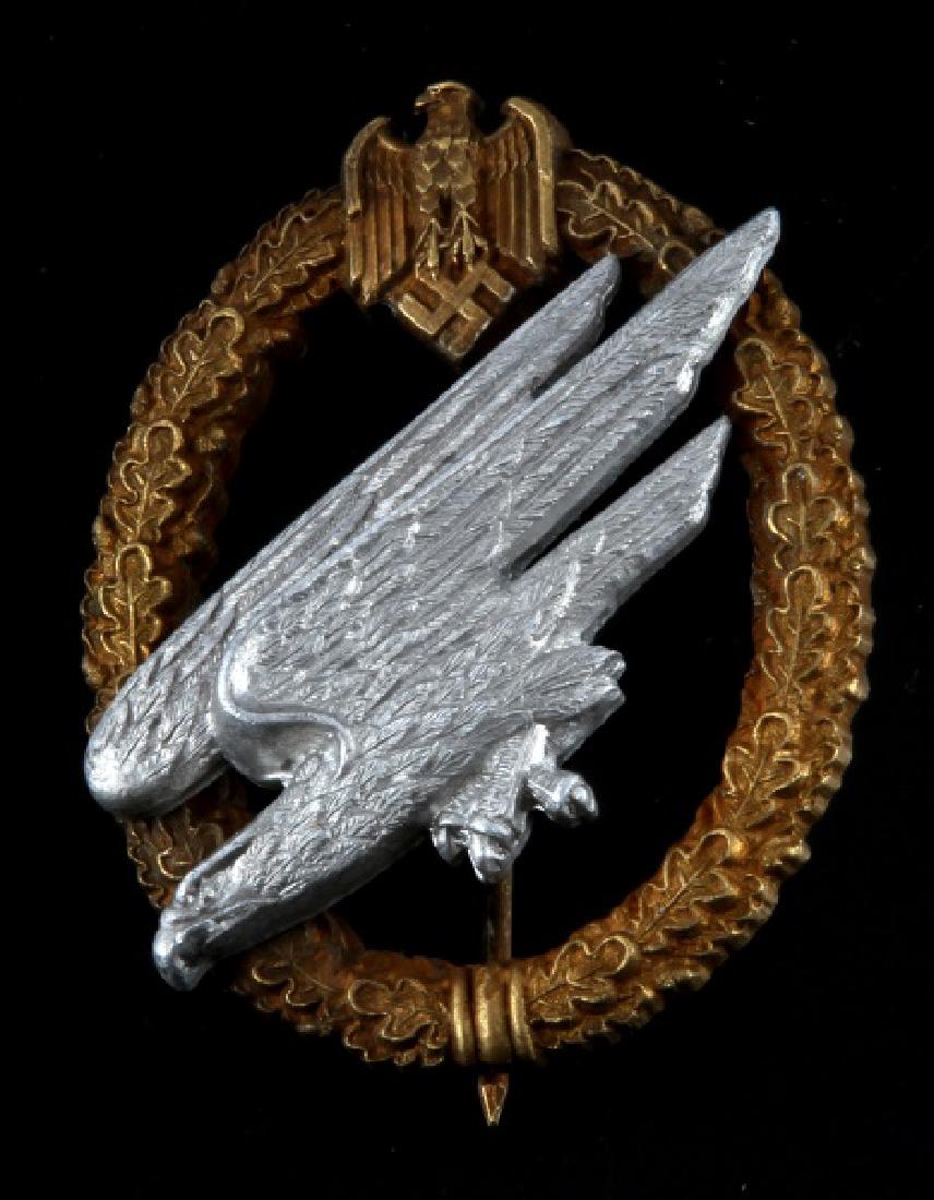 WWII GERMAN 3RD REICH ARMY HEER PARATROOPER BADGE: In very good condition with a straight vertical pinback. The back is marked C.E. Junker Berlin. This lot has a reserve.