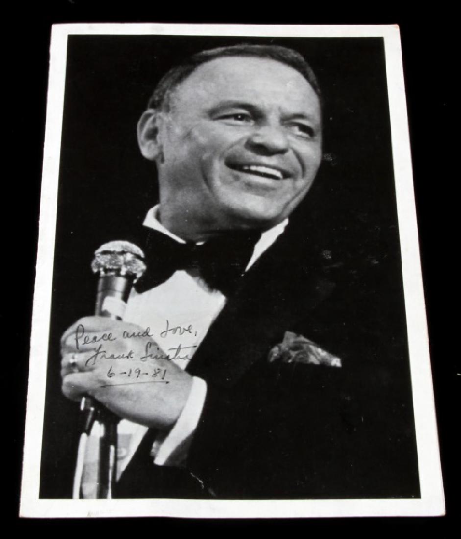 SIGNED PERFORMANCE PHOTO OF FRANK SINATRA: 5 1/2 inches by 8 1/2 inches black and white photo. It is signed peace and love Frank Sinatra 6-19-81. From a concert at the Masonic auditorium.